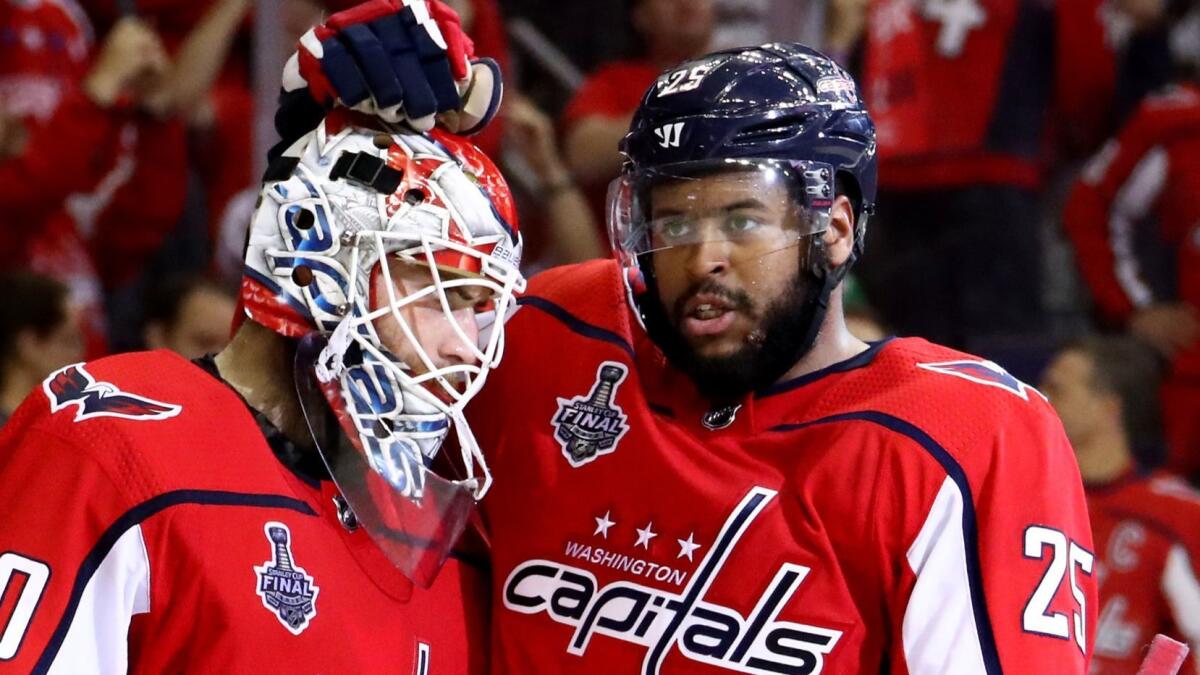 Devante Smith-Pelly (25) celebreates with goalie Braden Holtby after the Capitals' 6-2 win over Vegas in Game 4 of the 2018 NHL Stanley Cup Final.