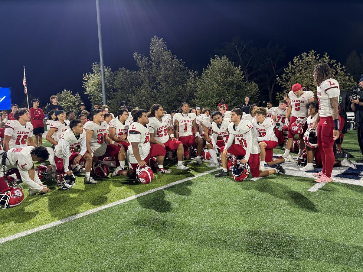 Orange Lutheran players gather after overcoming a 19-point halftime deficit to defeat Sierra Canyon 33-26.