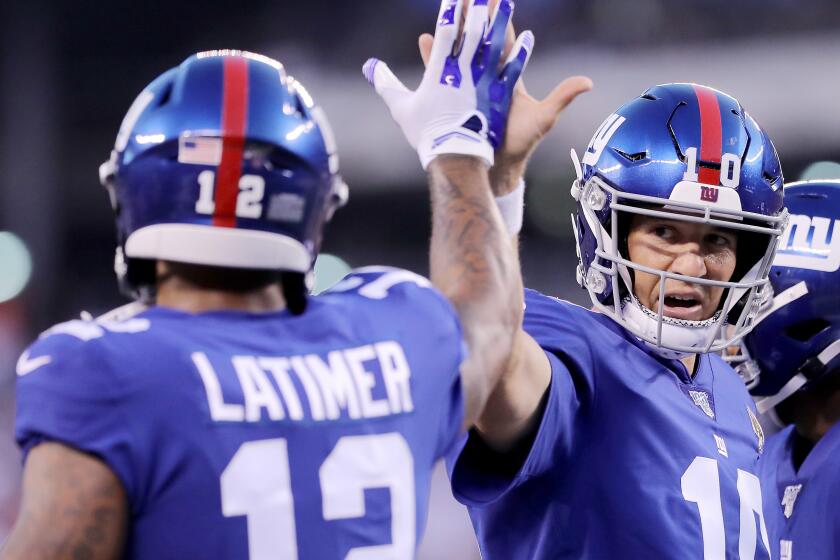 EAST RUTHERFORD, NEW JERSEY - AUGUST 16: Eli Manning #10 of the New York Giants celebrates with teammate Cody Latimer #12 after teammate Bennie Fowler III ran the ball in for a touchdown in the first quarter against the Chicago Bears during a preseason game at MetLife Stadium on August 16, 2019 in East Rutherford, New Jersey. (Photo by Elsa/Getty Images) ** OUTS - ELSENT, FPG, CM - OUTS * NM, PH, VA if sourced by CT, LA or MoD **