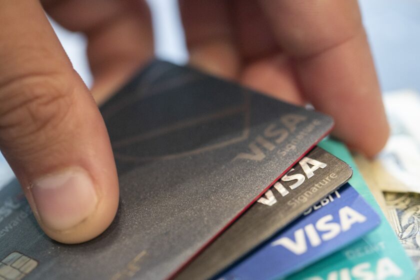 FILE - This Aug. 11, 2019 file photo shows Visa credit cards in New Orleans. With interest rates rising, the cost of borrowing is going up. This is especially the case for credit cards, as they have high annual percentage rates that vary as interest rates change. (AP Photo/Jenny Kane, File)