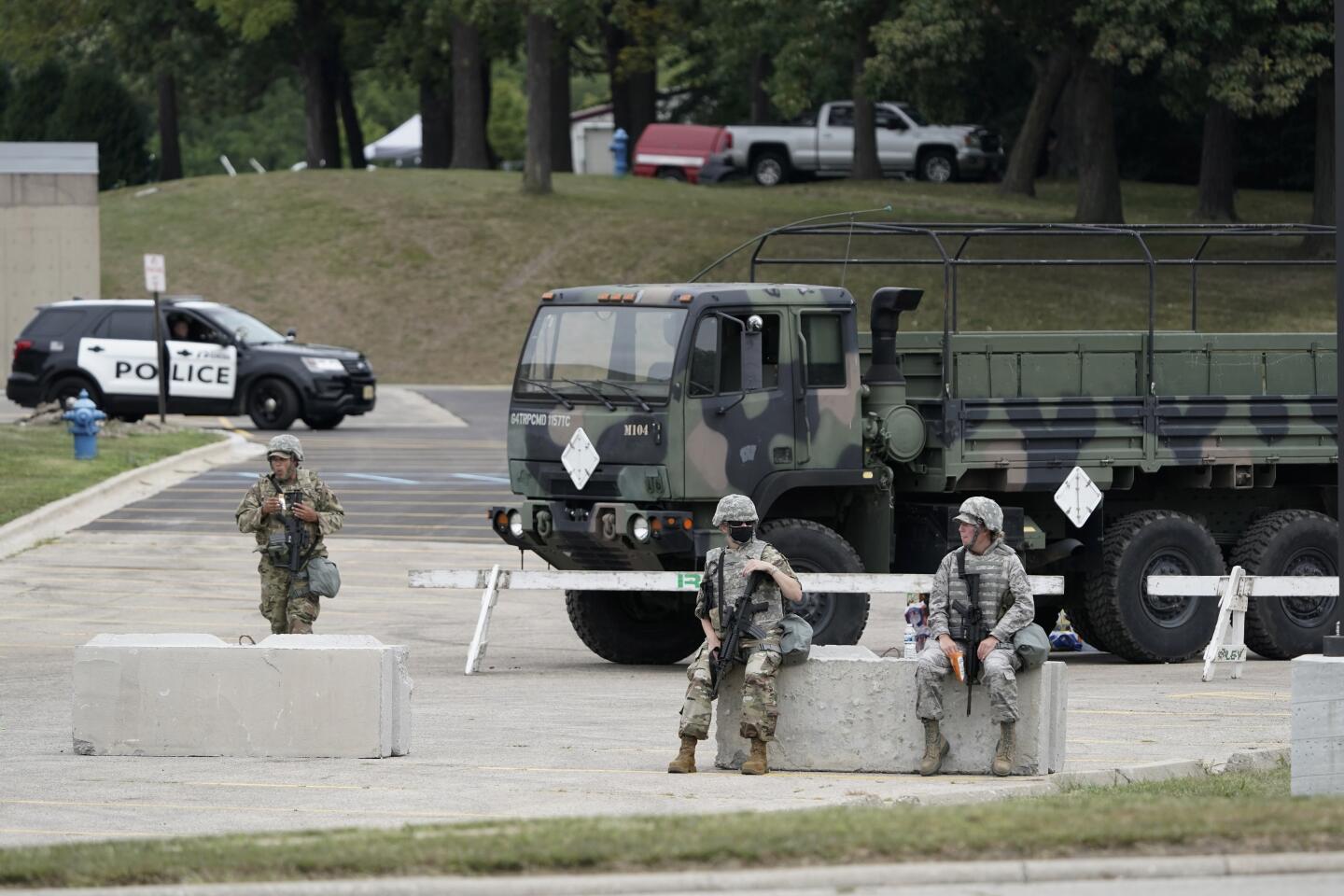 National Guard soldiers supplement local police to secure a school in Kenosha, Wis., where Trump was visiting.