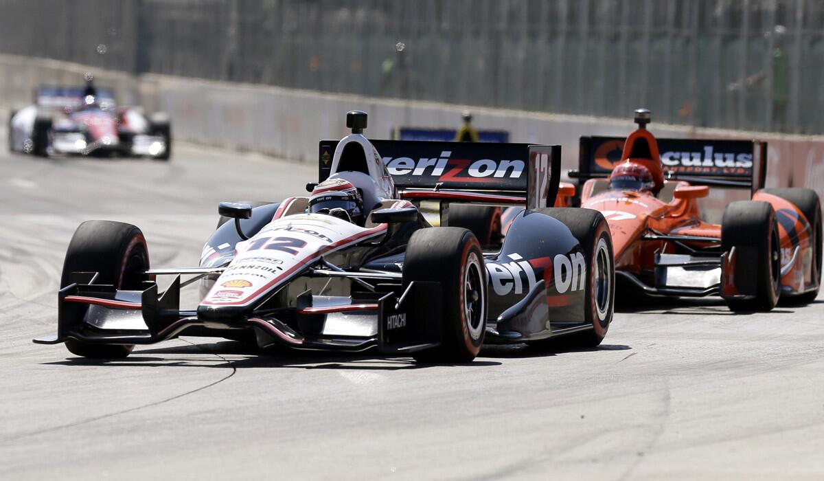 Will Power leads Simon Pagenaud through Turn 1 on Saturday during the first race of the IndyCar Detroit Grand Prix doubleheader.