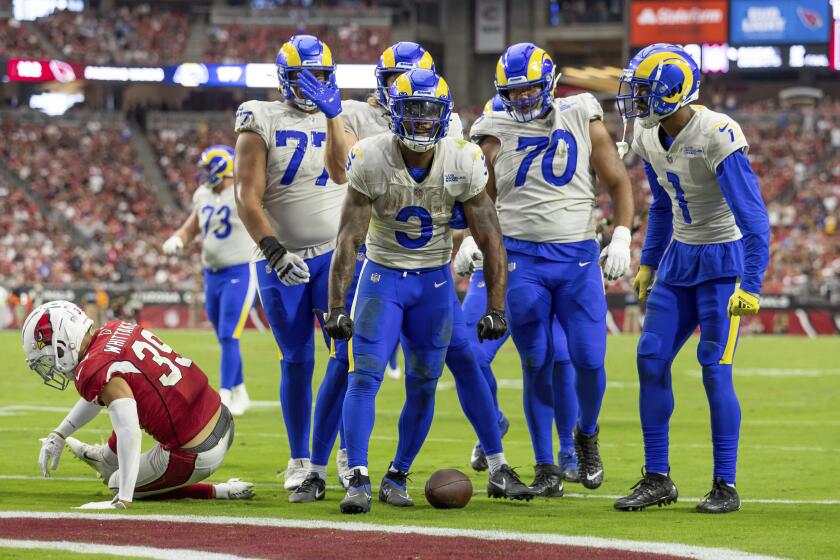 Running back (3) Cam Akers of the Los Angeles Rams celebrates with teammates after running the ball for a touchdown