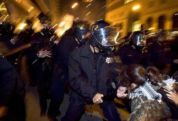 ... What had started as a peaceful demonstration Wednesday over the Jan. 1 shooting of Oscar Grant escalated into trouble. At least three cars were set on fire, many other automobiles were damaged, and windows were broken on some downtown stores. ... Photo: An Oakland police officer hits a demonstrator with a night stick while attempting to clear city streets. Submit your own photos and video from this event.