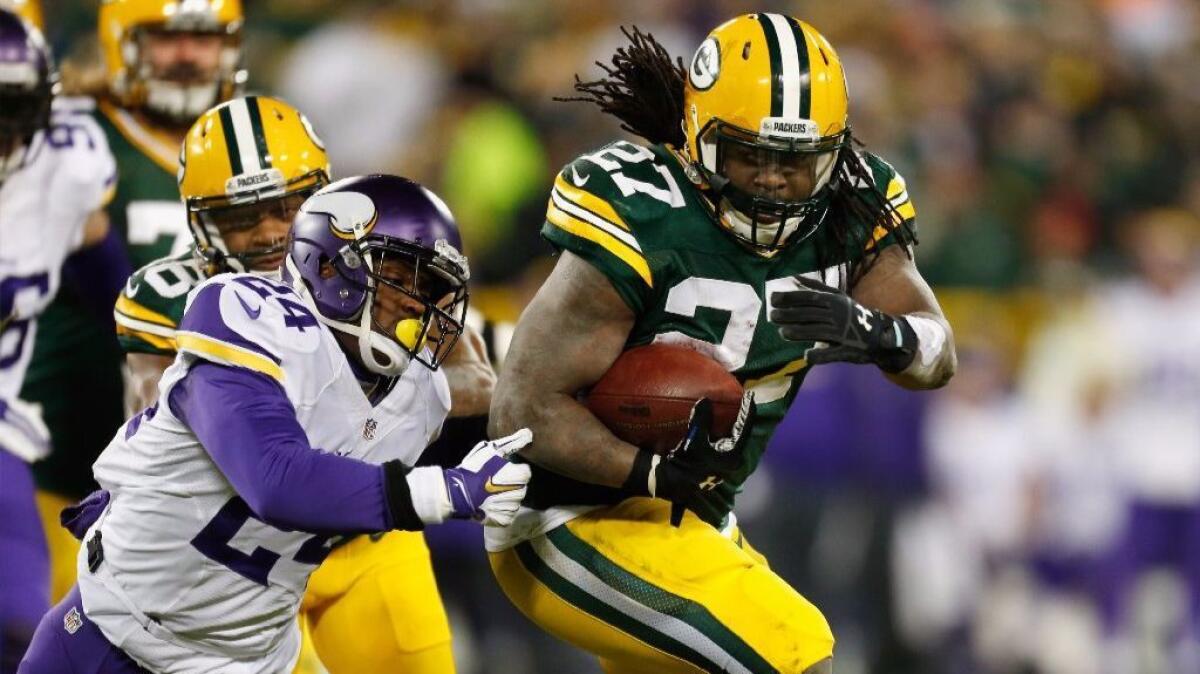 Vikings defensive back Captain Munnerlyn (24)attempts to tackle Packer running back Eddie Lacy (27)during a game at Lambeau Field on Jan. 3.