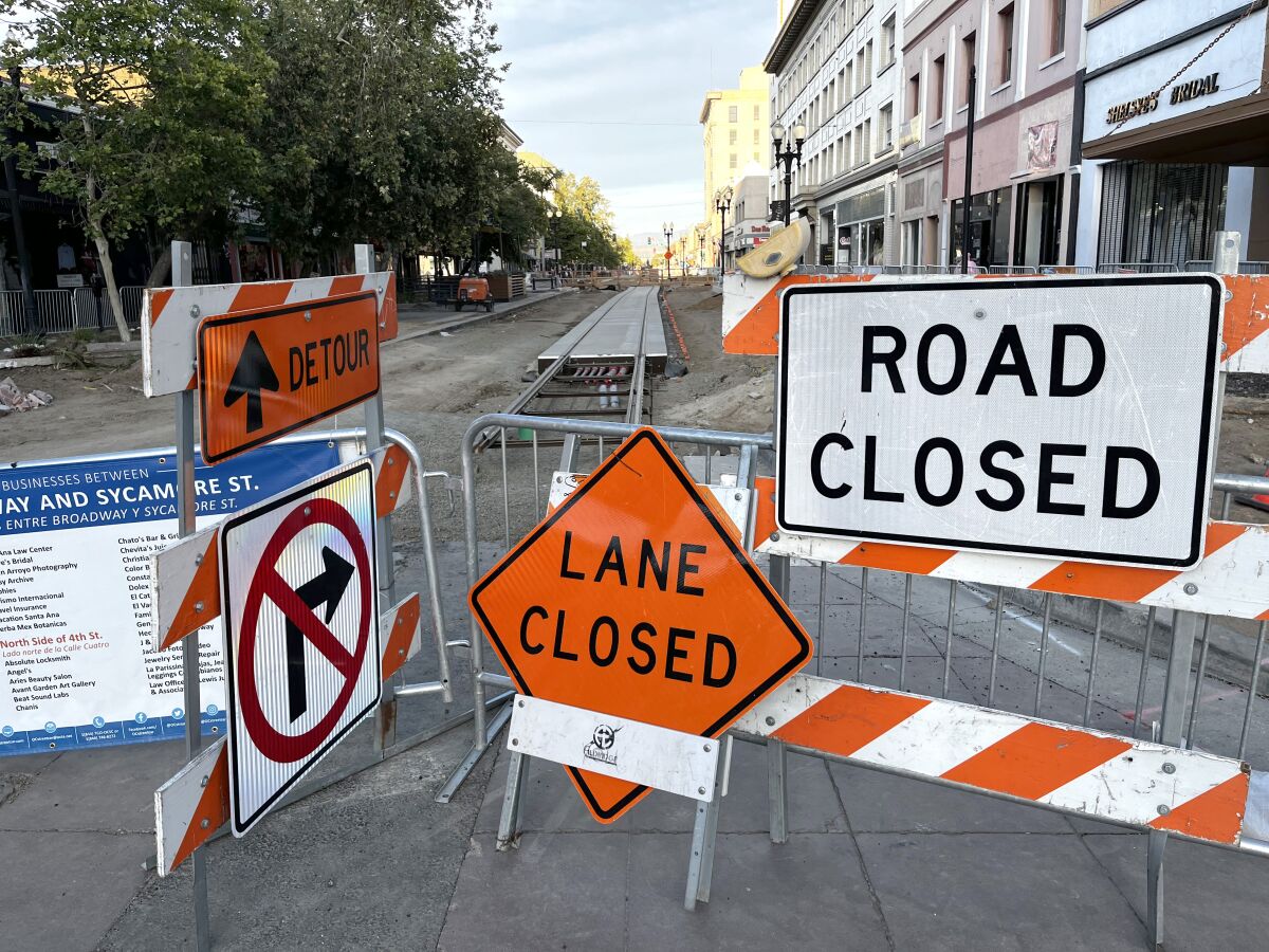 Road closure signs blocking entrance to 4th Street in downtown Santa Ana.