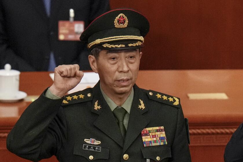 FILE - Newly elected Chinese Defense Minister Gen. Li Shangfu takes his oath during a session of China's National People's Congress (NPC) at the Great Hall of the People in Beijing on March 12, 2023. China has replaced Defense Minister Gen. Li, who has been out of public view for almost two months with little explanation, state media reported Tuesday, Oct. 24. (AP Photo/Andy Wong, File)