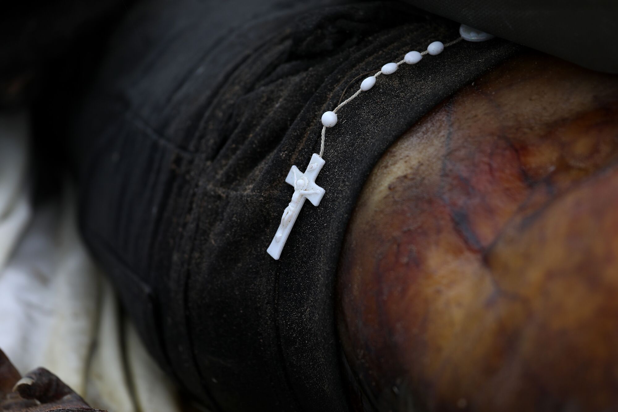A rosary on a body.