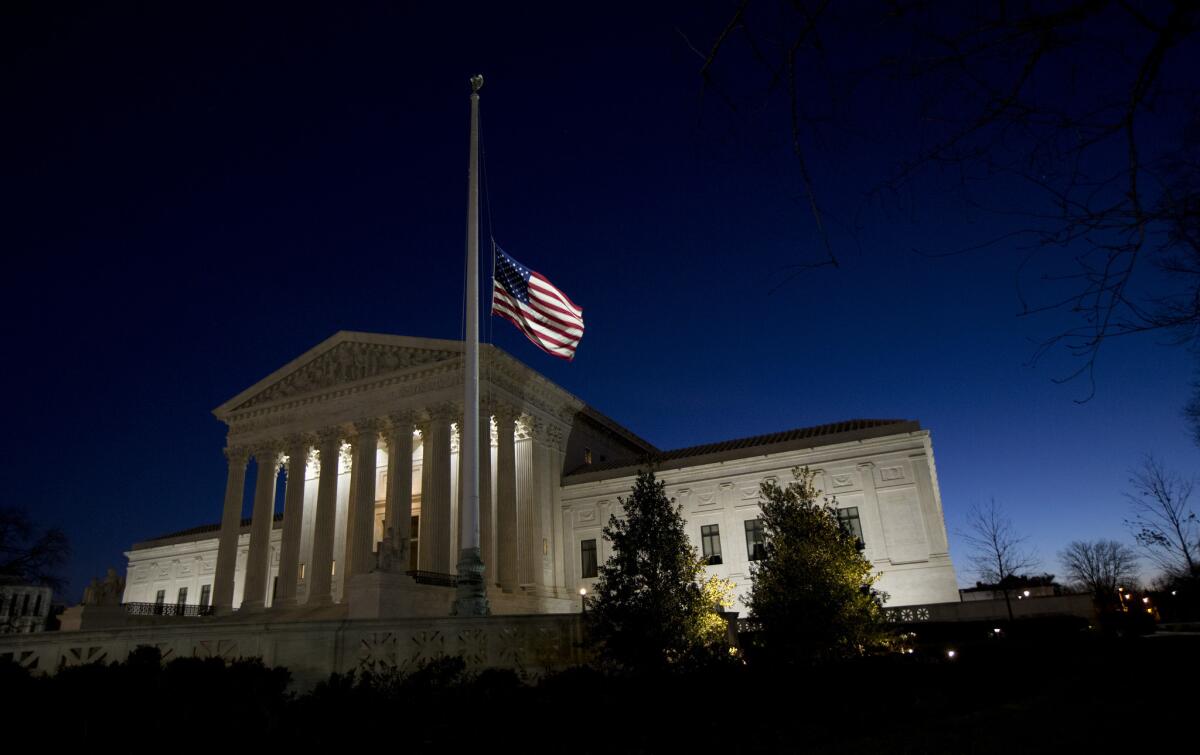 An American flag flies at half-staff in front of the U.S. Supreme Court building in honor of Justice Antonin Scalia on Feb. 14.