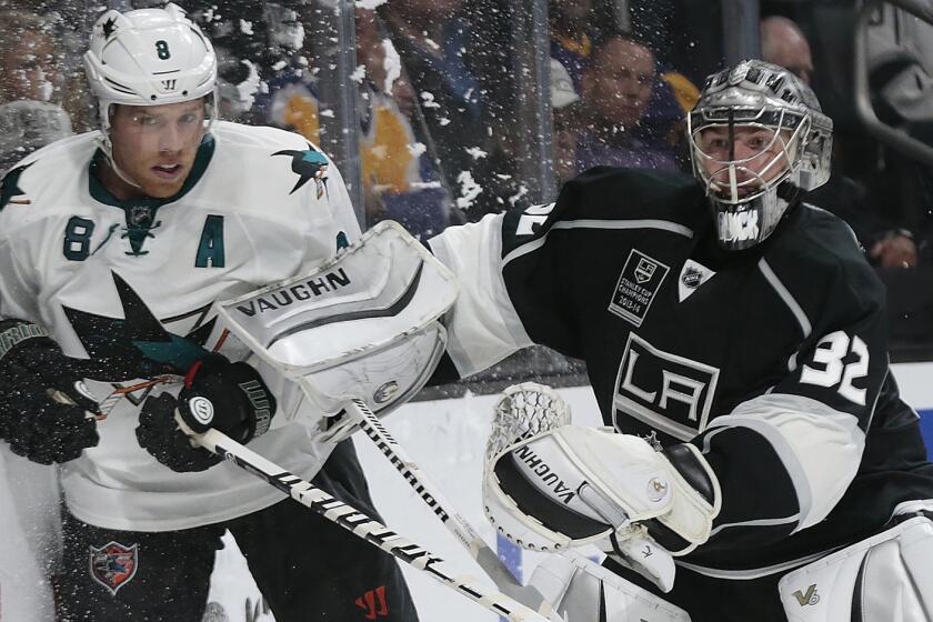 Kings goalie Jonathan Quick, right, makes contract with San Jose Sharks forward Joe Pavelski during a game at Staples Center on Oct. 8.