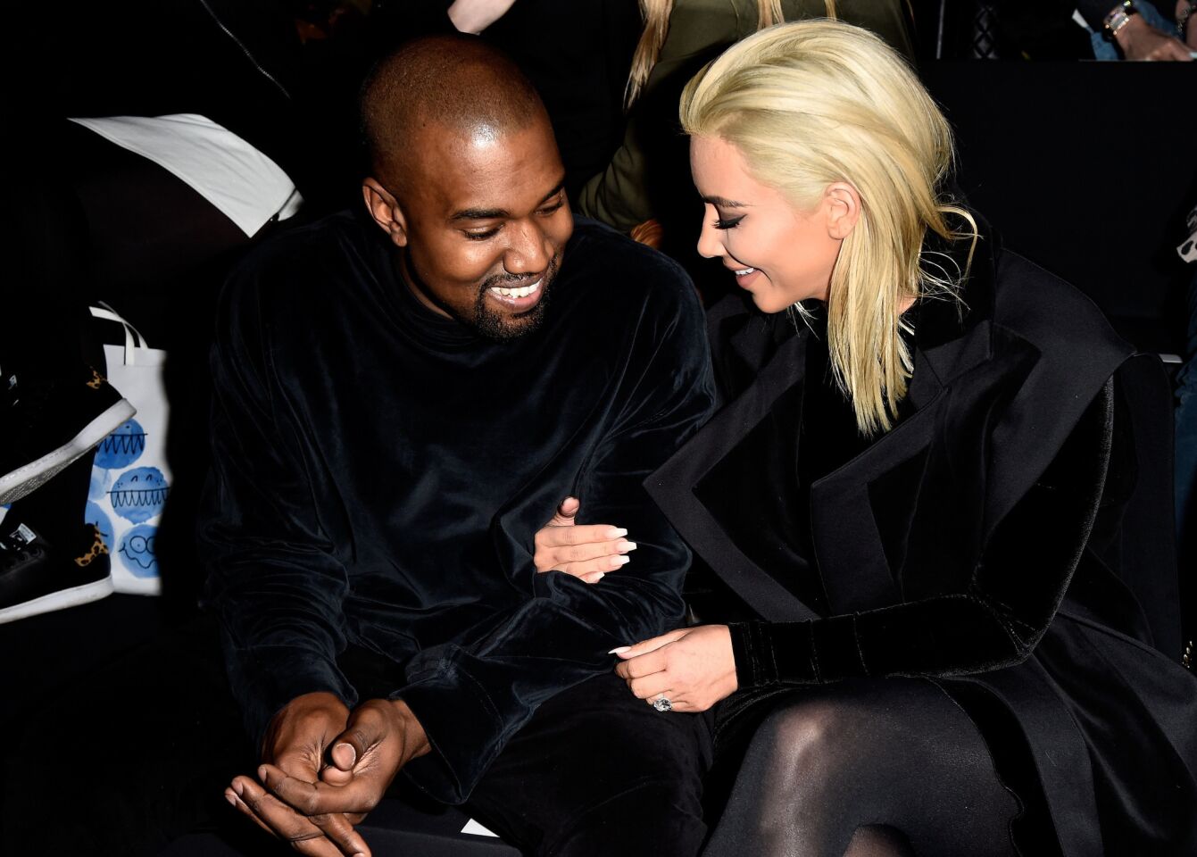 Kardashian debuts her platinum blond dye job at the Balmain show in Paris on March 5, 2015.