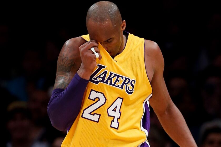 Lakers forward Kobe Bryant catches his breath during a break in the action against the Spurs on Friday night at Staples Center.