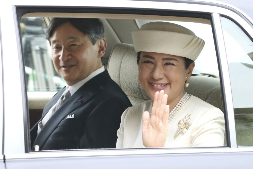 Japan's new Emperor Naruhito and new Empress Masako are driven to Imperial Palace to greet Emperor Emeritus Akihito and Empress Emerita Michiko in Tokyo, Wednesday, May 1, 2019. Naruhito succeeded to the Chrysanthemum Throne Wednesday after his father Akihito abdicated Tuesday. (AP Photo/Koji Sasahara)