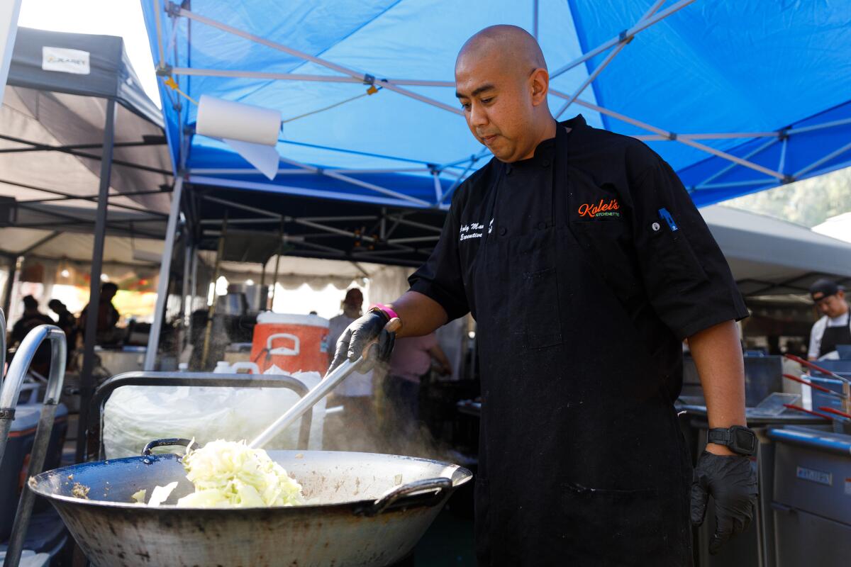 Chef Andy Mangiduyos prepares food at Kalei’s Kitchenette’s food stall during the annual Pacific Islander Festival