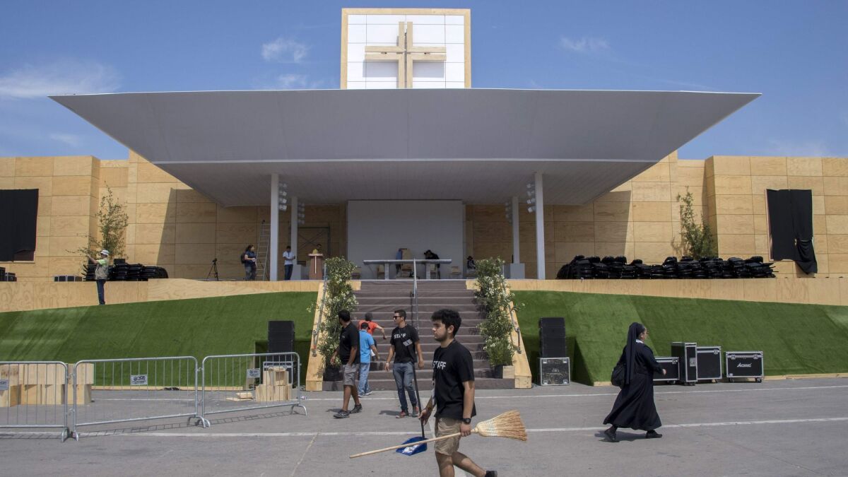 Workers on Jan. 14, 2018, set up the stage on which Pope Francis will officiate the first open-air Mass during his visit to Chile, at O'Higgins Park in Santiago.