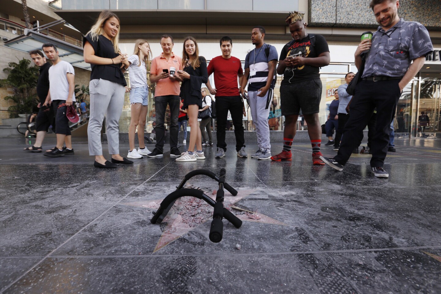 Pedestrians view the spot where Donald Trump's star had been on the Hollywood Walk of Fame before it was vandalized on July 25, 2018.
