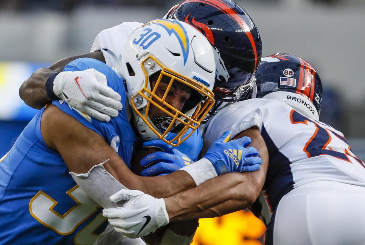Chargers running back Austin Ekeler carries the ball during a game against the Denver Broncos.