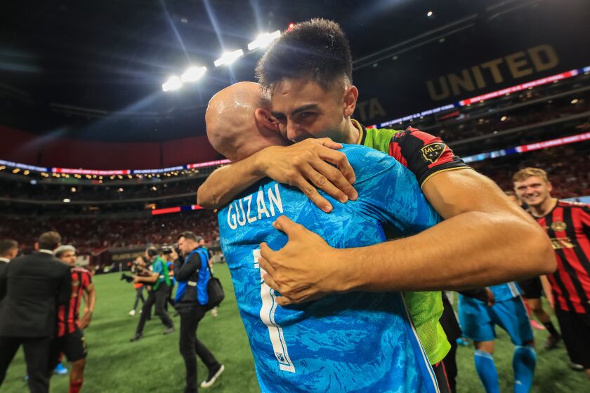 Pity Martinez, left, celebrates with goalkeeper Brad Guzan after Atlanta United won the U.S. Open Cup on Aug. 27.