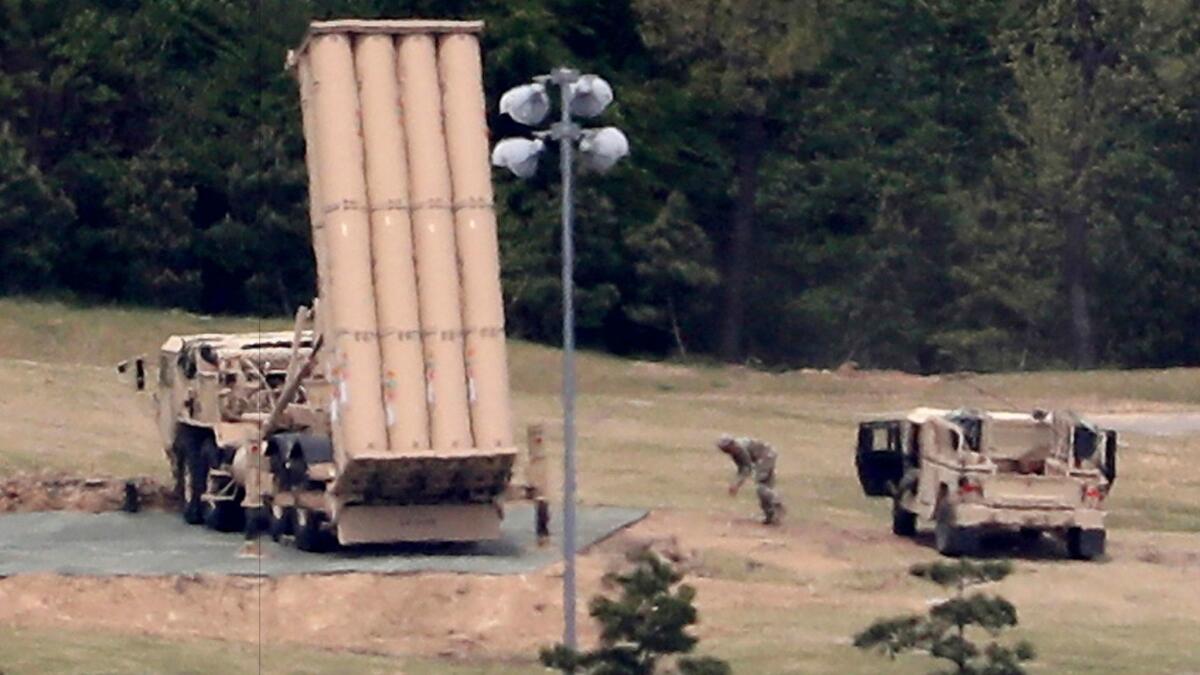 Crews install the U.S. Terminal High Altitude Area Defense, or THAAD, anti-missile system at a former golf course in Seongju, South Korea, on May 2.