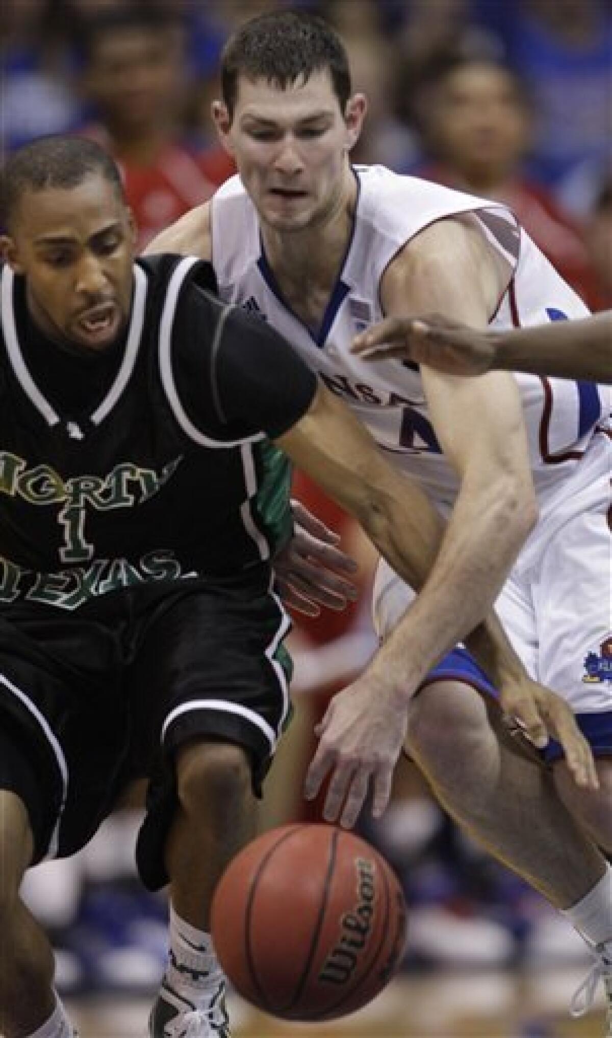 Kansas' Markieff Morris (21) with his twin brother Marcus Morris, left,  during the second half of an NCAA college basketball game against La Salle  Saturday, Dec. 12, 2009 in Kansas City, Mo. (