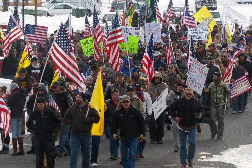 Protesters march in support of an Oregon ranching family facing additional prison time for arson on federal land.