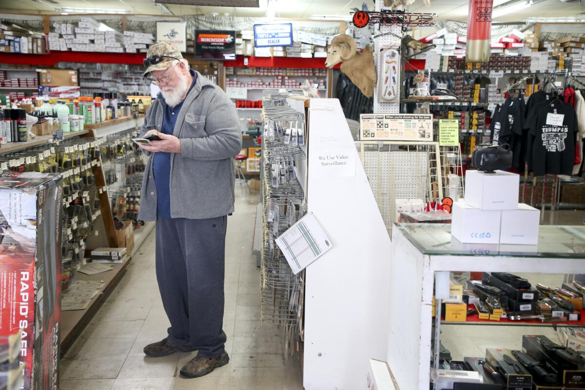 A customer shops at Dong's Guns, Ammo and Reloading in Tulsa, Okla.