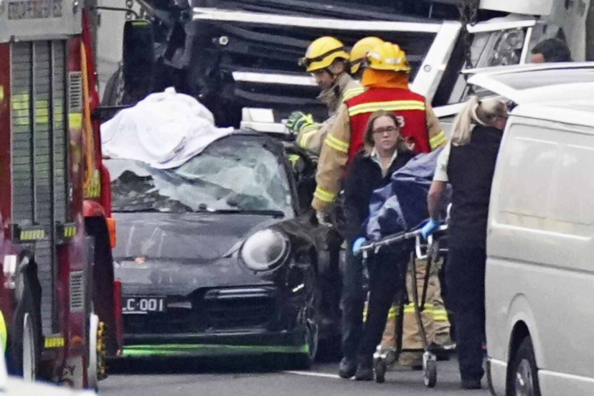 Emergency personnel work at the scene of a collision in Melbourne, Australia, on Thursday, which killed four police officers.