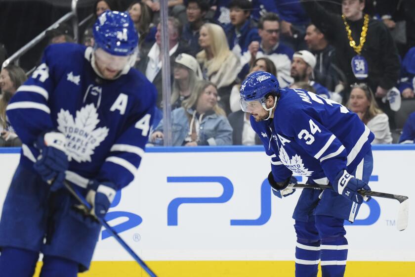 Toronto Maple Leafs' Auston Matthews (34) and Morgan Rielly (44) react after Boston Bruins' Brad Marchand scored an empty-net goal during the third period in Game 3 of an NHL hockey Stanley Cup first-round playoff series in Toronto on Wednesday, April 24, 2024. (Nathan Denette/The Canadian Press via AP)