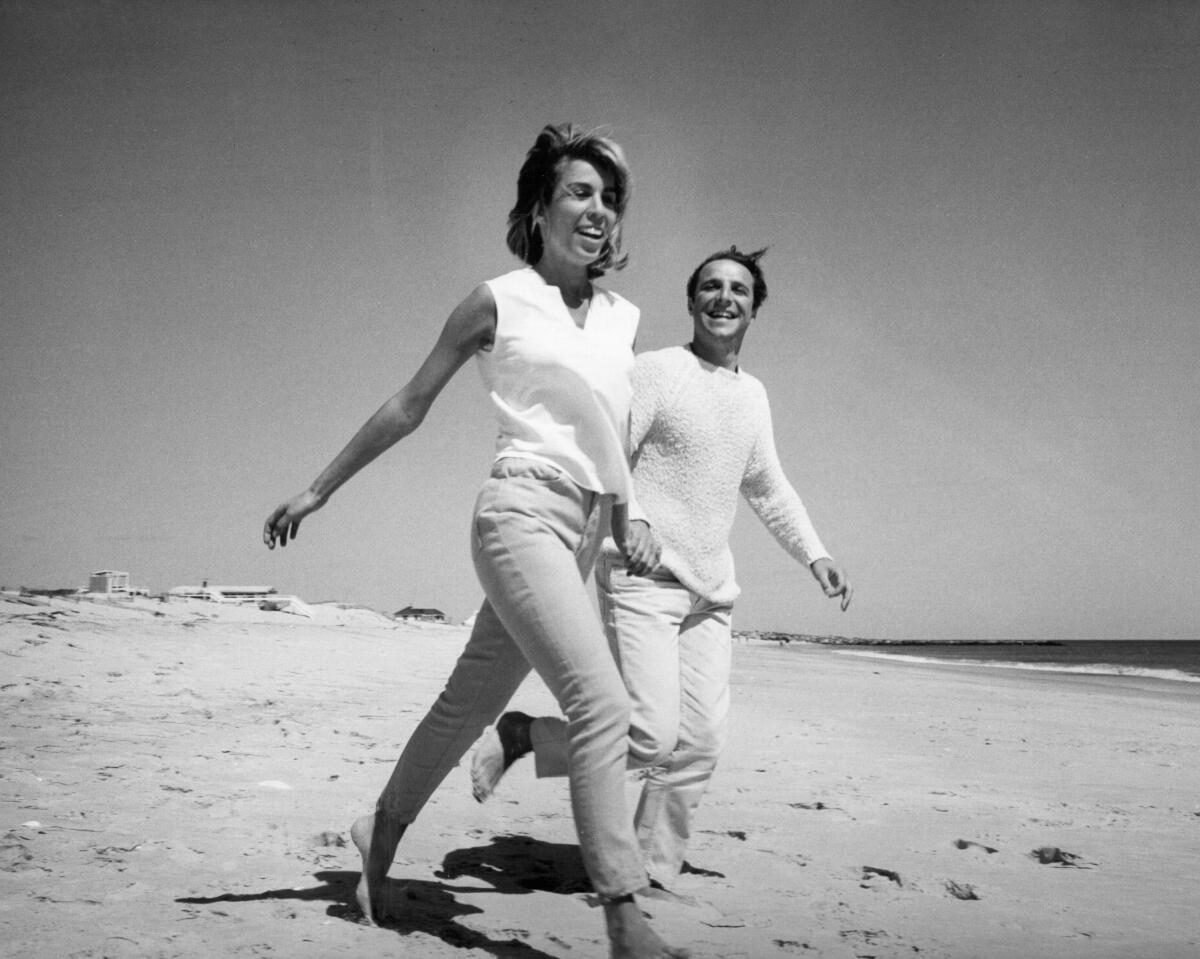 Cynthia Weil and Barry Mann walk on a beach