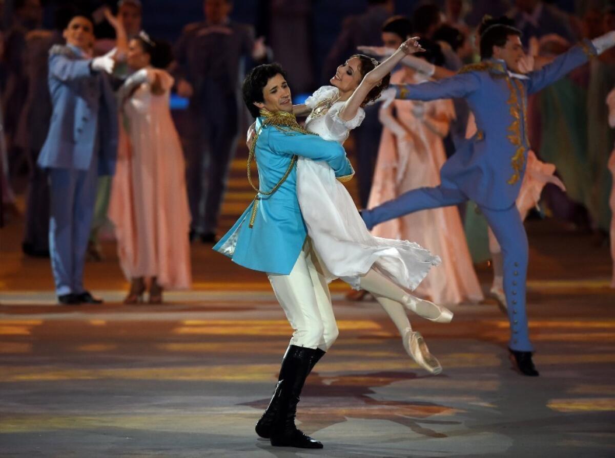 Dancers Danila Korsuntsev and Svetlana Zakharova perform during the "War and Peace" segment of the opening ceremony entertainment.