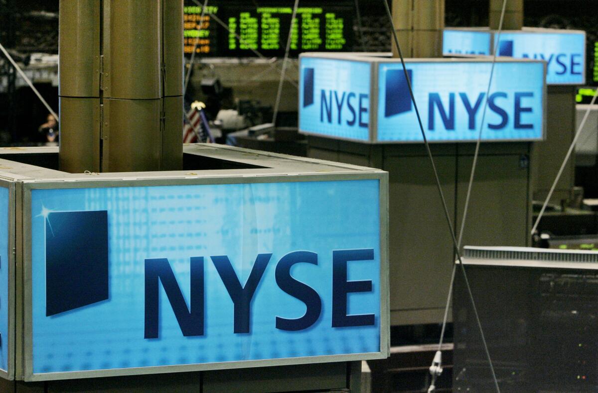 New York Stock Exchange signs top trading posts on the floor of the NYSE. 