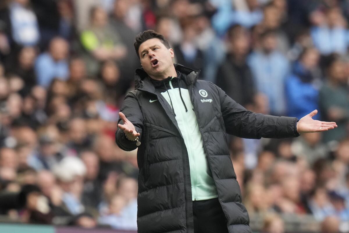 Chelsea coach Mauricio Pochettino spreads his arms and reacts incredulously during an FA Cup semifinal match