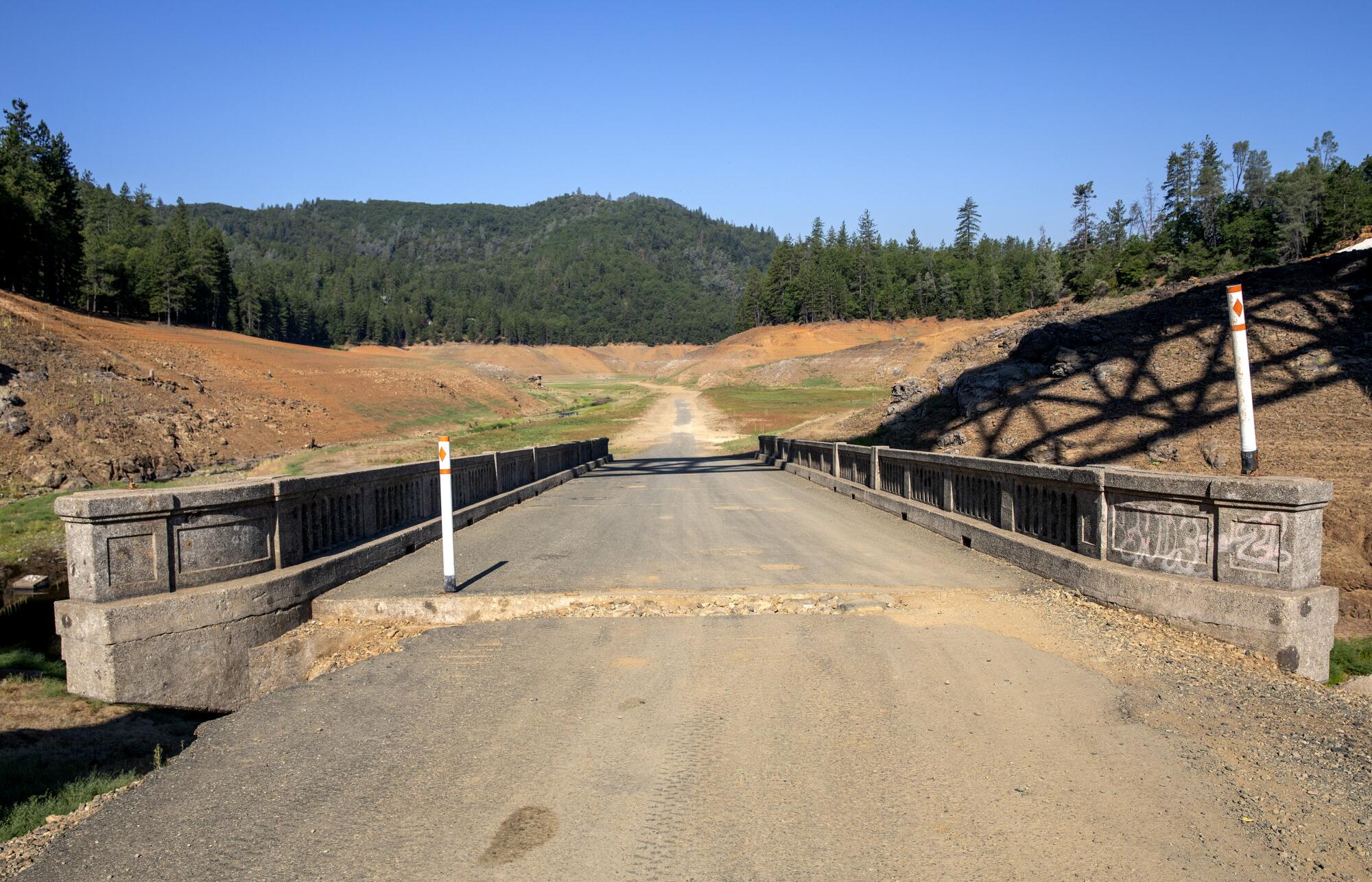 An old roadway and bridge revealed by receding water levels on Lake Shasta.
