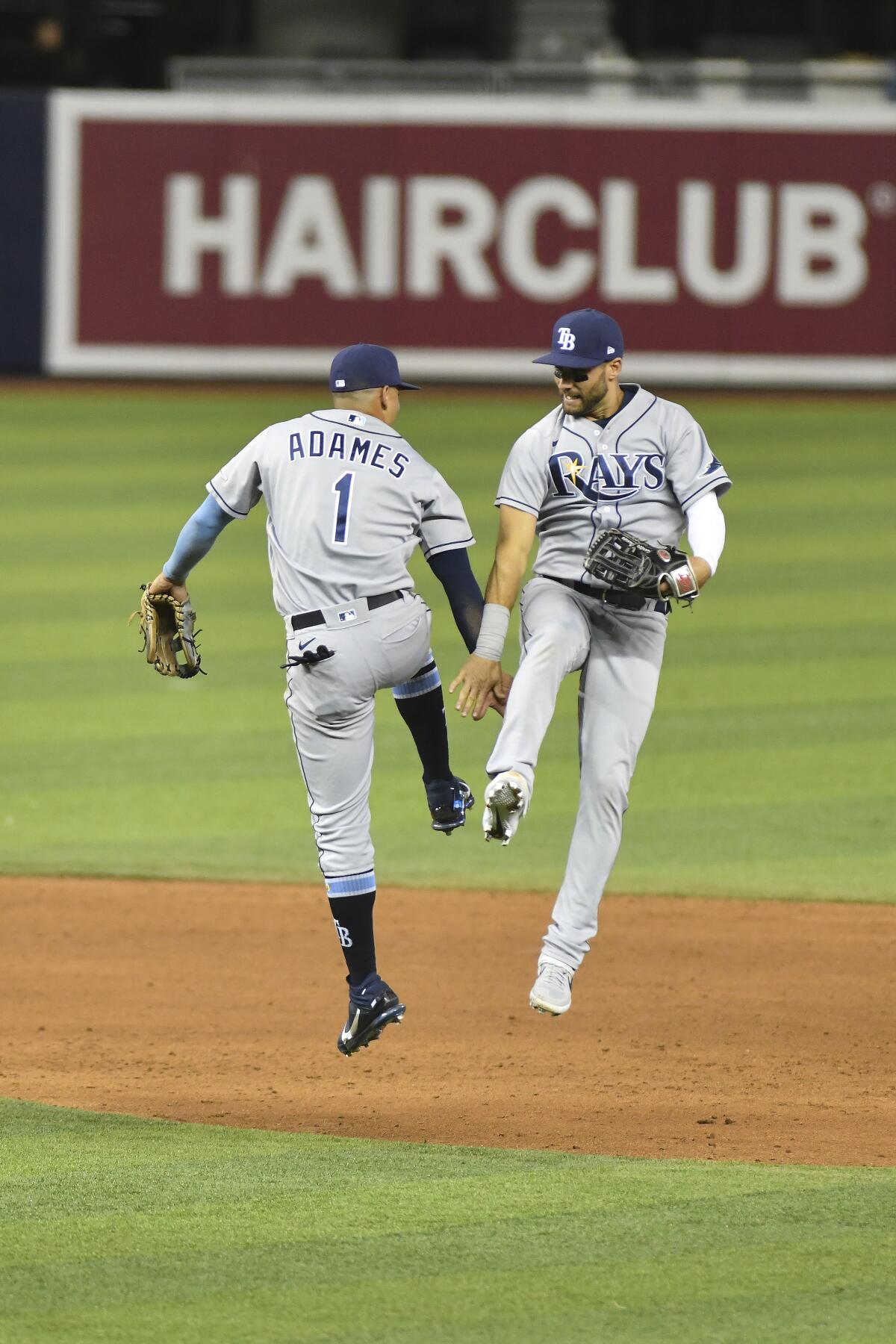 Tampa Bay Rays shortstop Willy Adames, left, and center fielder Kevin Kiermaier celebrate after defeating the Miami Marlins in a baseball game Friday, April 2, 2021, in Miami. (AP Photo/Gaston De Cardenas)