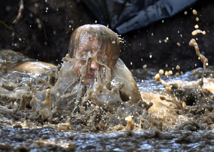 A visitor to Huntington Beach's Adventure Playground in 2011 is drenched in muddy water. 
