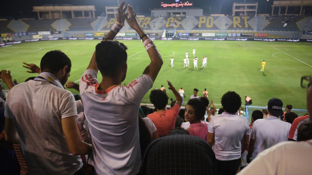 Fans in Cairo cheer during a soccer match Saturday between Zamalek and ENPPI.