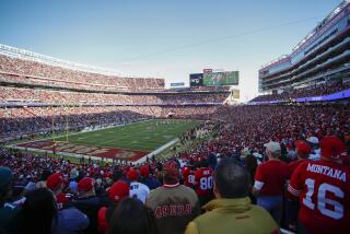 FILE - Fans at Levi's Stadium watch the first half of an NFL divisional round playoff football game.