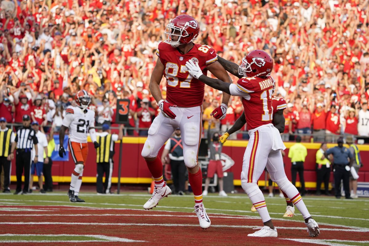 Kansas City Chiefs' Travis Kelce, left is congratulated by Mecole Hardman (17) after scoring during the second half of an NFL football game against the Cleveland Browns Sunday, Sept. 12, 2021, in Kansas City, Mo. (AP Photo/Ed Zurga)