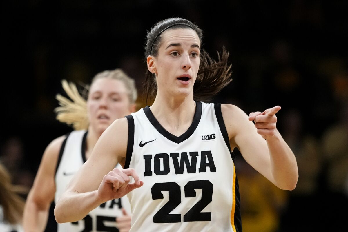Iowa guard Caitlin Clark reacts after making a basket during the first half of an NCAA college basketball game against North Carolina State, Thursday, Dec. 1, 2022, in Iowa City, Iowa. (AP Photo/Charlie Neibergall)