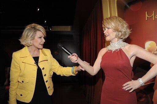 In this handout photo courtesy of Madame Tussauds Hollywood, comedienne Joan Rivers touches a wax figure of herself while touring Madame Tussauds Hollywood in Los Angeles on Monday, July 27, 2009. (AP Photo/Madame Tussauds Hollywood, Dan Steinberg)