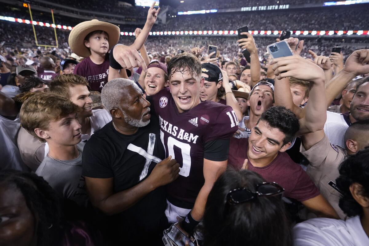 Texas A&M quarterback Zach Calzada is surrounded by fans after beating Alabama