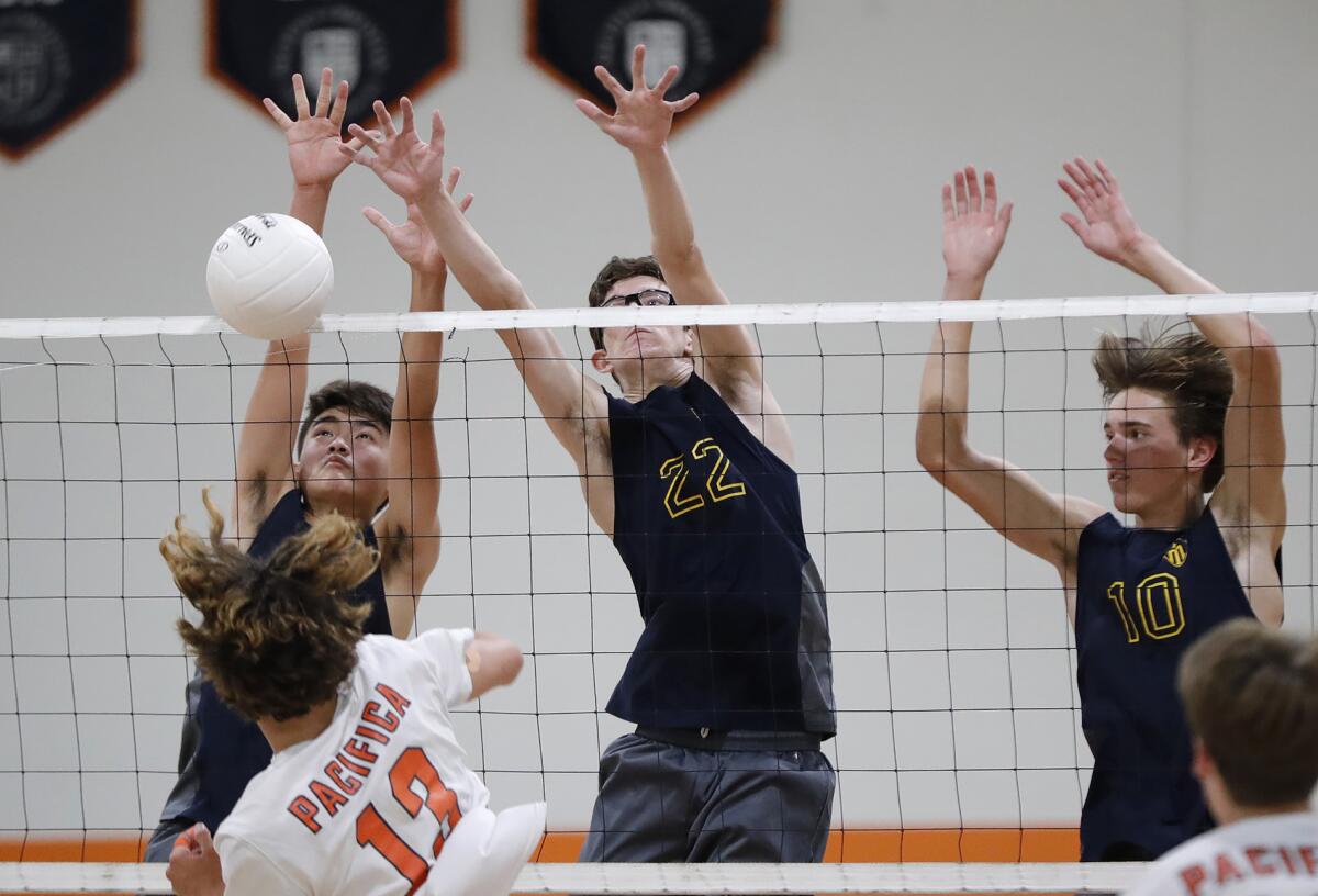 Marina's Chris Whitener (22) blocks Pacifica Christian's Miller Clark during a CIF Southern Section Division 4 quarterfinal.