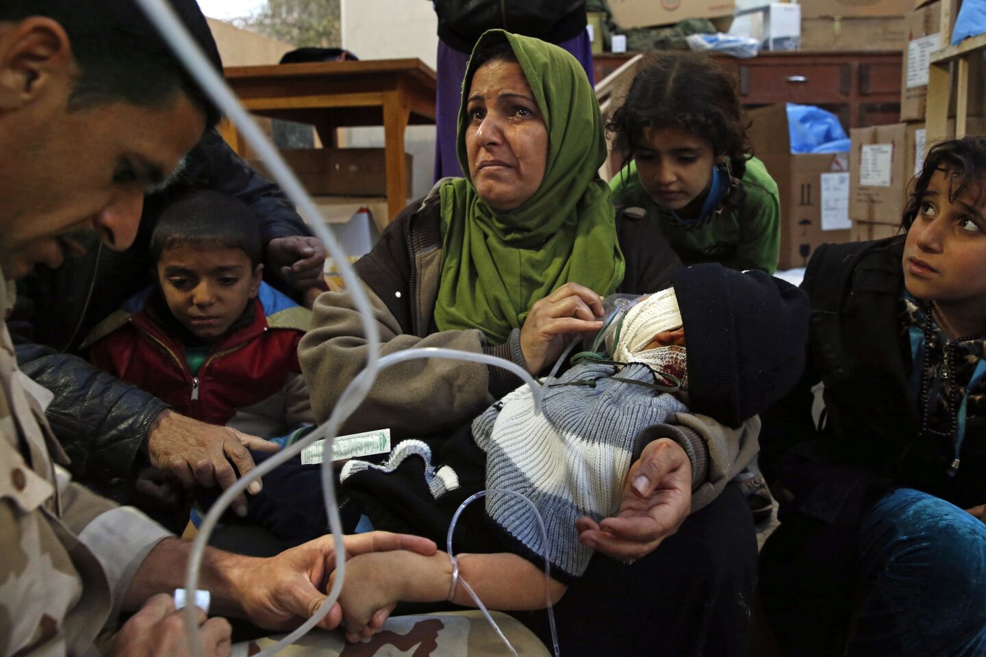 Wafa Abdel Raza, 39, holds her son Mahmoud Setar, 4, as the doctors give him oxygen and and fluids. The boy's head was badly injured when a truck bomb exploded near their home. "We were sleeping in the house," said Raza. "The army was close to us and we made food for them. They were waiting behind the house and a suicide car came." Her son recovered as the night progressed.