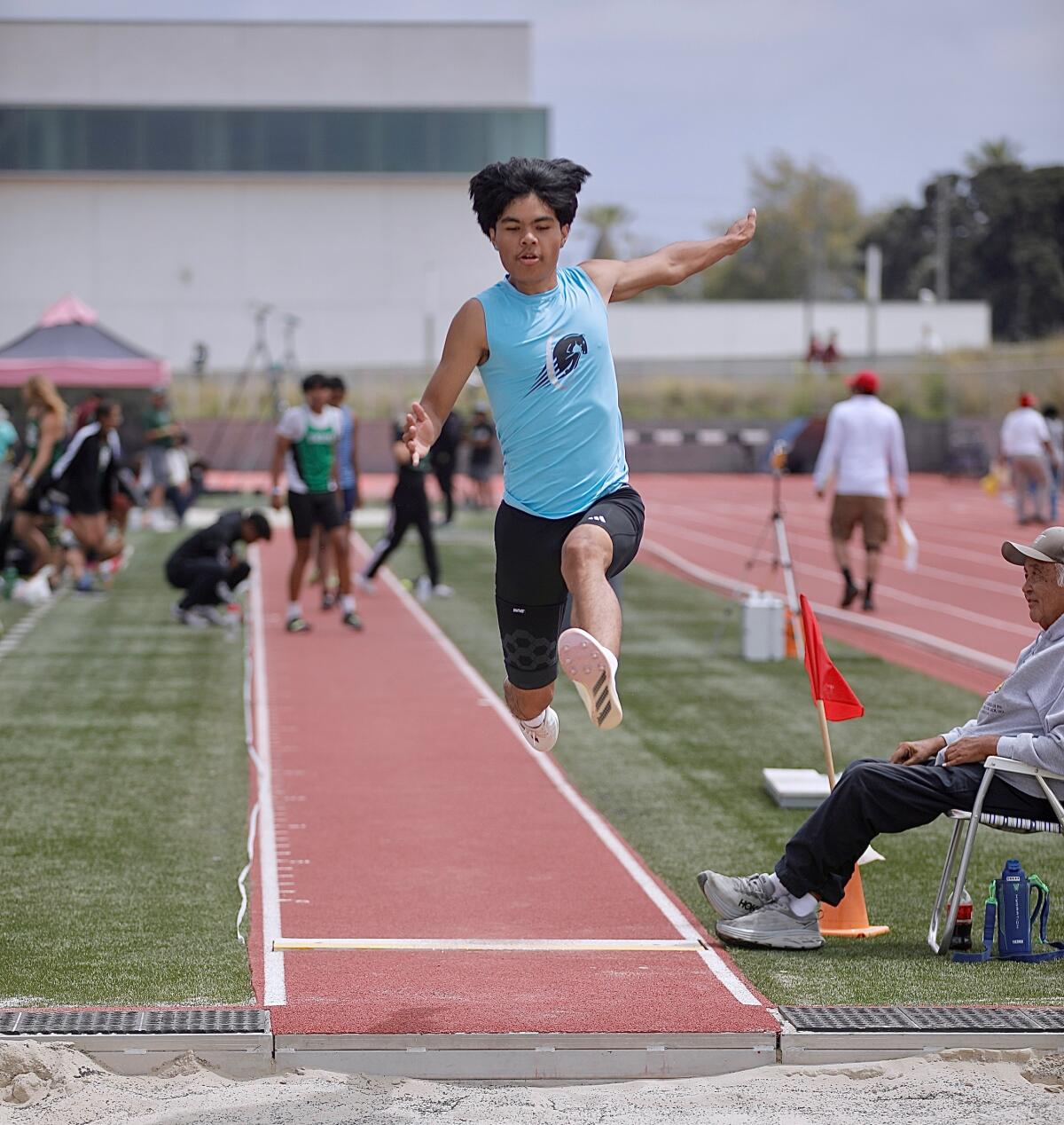 Carson junior Jerald Martin Evangelista leaps 22 feet, 3½ inches in the long jump.