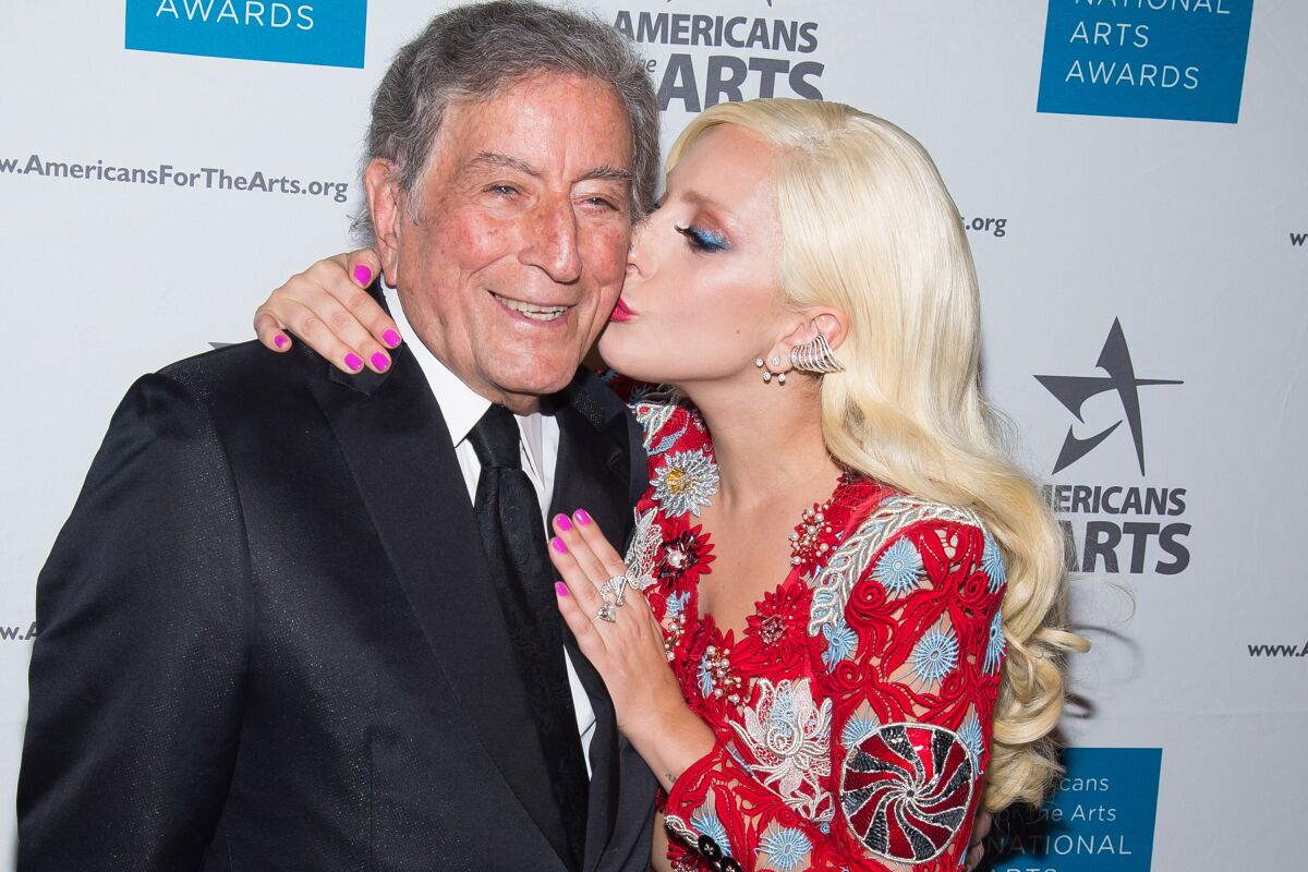 Lady Gaga kisses Tony Bennett  on the cheek at an event