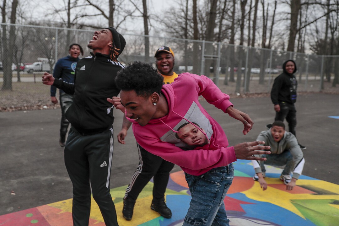 Taevion Rushing, left, plays pickup basketball with Taras Rushing, front, and other members of his family.