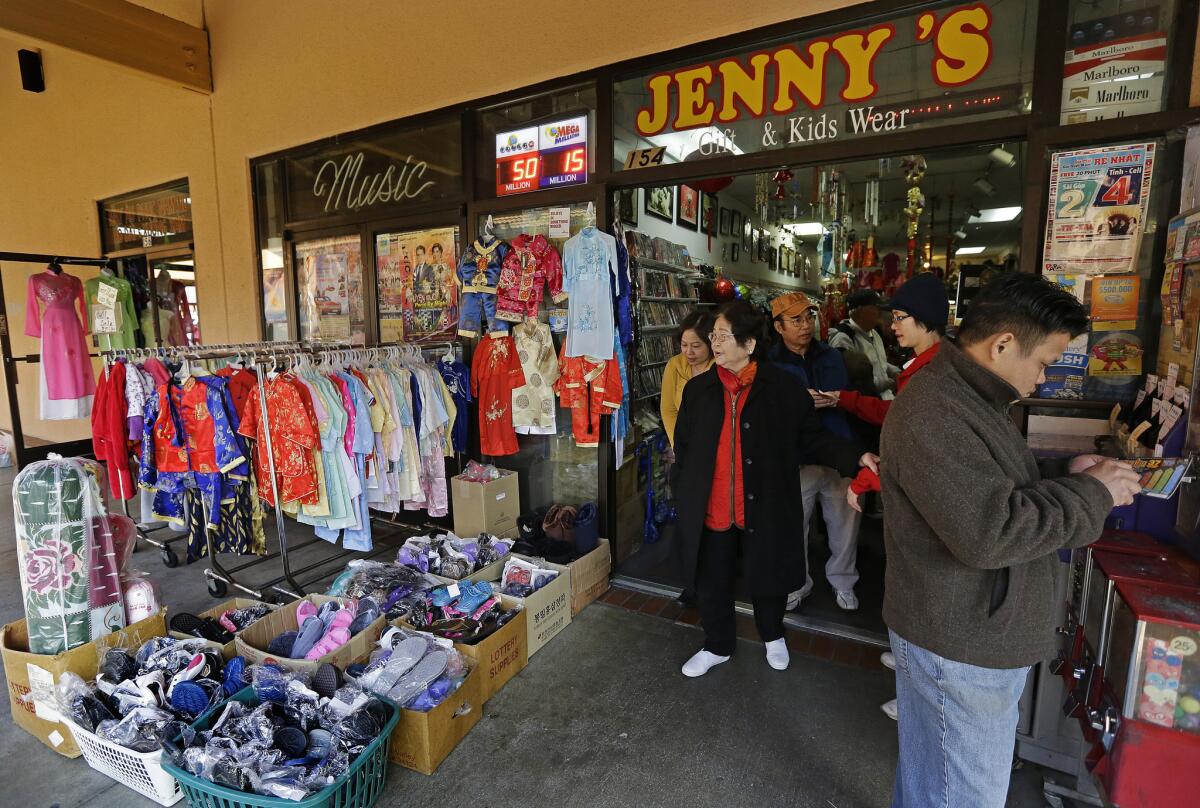 Customers crowd Jenny's Gift Shop in San Jose, where one of two winning tickets was sold for last month's $648-million Mega Millions jackpot drawing.