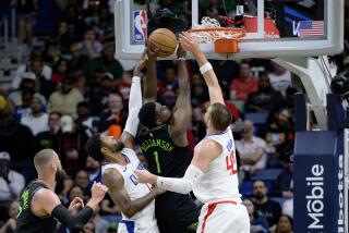 New Orleans Pelicans forward Zion Williamson (1) shoots between Los Angeles Clippers.