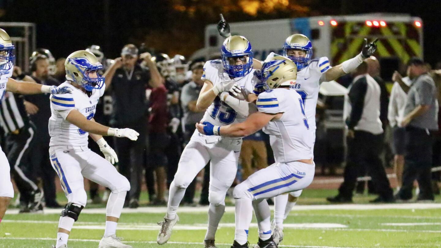 Santa Margarita's Quinton Buchman (13) celebrates his game-clinching interception in the final seconds to seal a 36-35 victory over JSerra on Oct. 27.