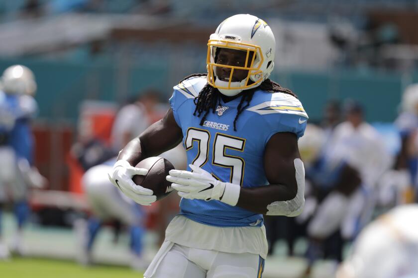 Los Angeles Chargers running back Melvin Gordon (25) stretches before an NFL football game against the Miami Dolphins, Sunday, Sept. 29, 2019, in Miami Gardens, Fla. AP Photo/Lynne Sladky)